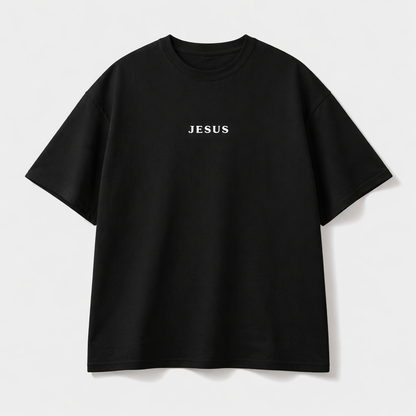 Camisa oversize negra con texto JESUS en blanco - vista flat lay